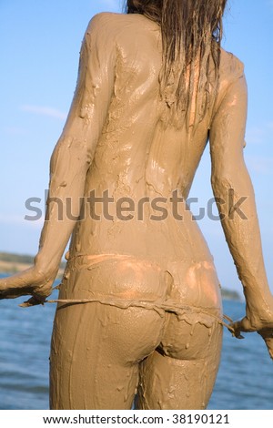 Beautiful female back and buttocks in the mud