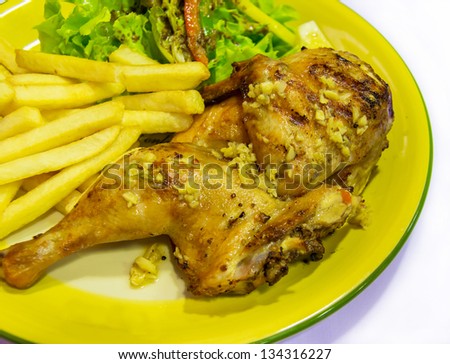 Roast chicken legs with garlic and french fries in plate in western style cuisine food