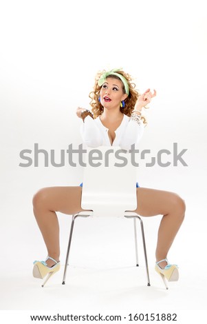 Pin-Up, beautiful girl in a classic pin up pose with blue short and blouse on a white background. American style