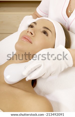 Laser hair removal in professional studio. Beautiful brunette woman.
