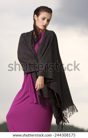 Portrait of young adult attractive and sexy pretty brunette woman posing in violet dress.