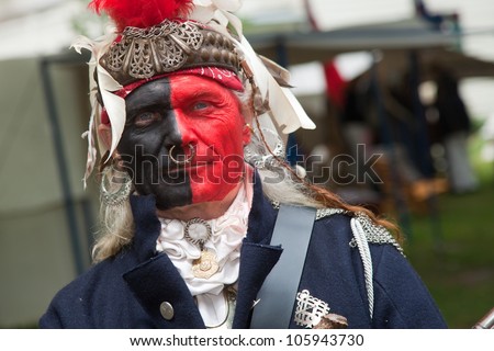 STONEY CREEK, ONTARIO - JUNE 3: Native Indian painted in British colors at a War of 1812 re-enactment at Stoney Creek Ontario, June 3, 2012