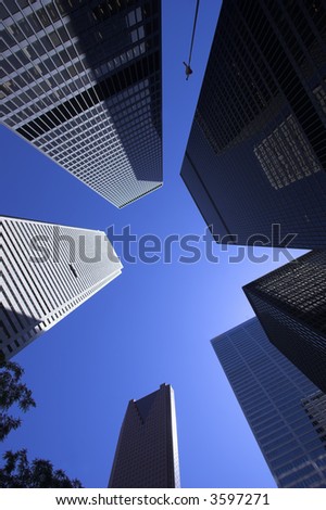 Skyward wide angle view of very tall office towers on a bright sunny day