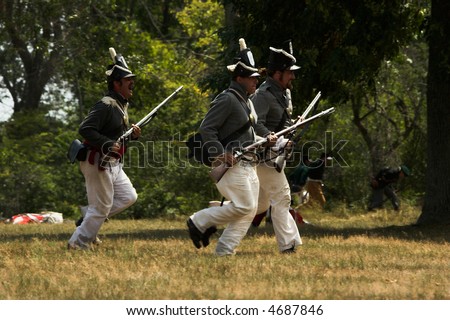 American soldiers charging in a War of 1812 battle re-enactment.