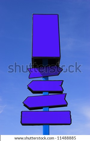 Blue directional signpost against a blue sky. Place your signs/logos.