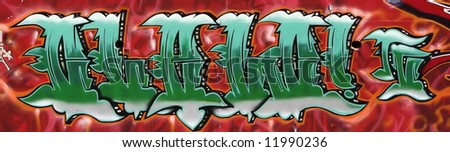 Green, white and black graffiti tag on a red wall