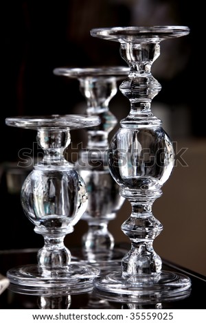 High contrast image of a glass candle holders designed for large pillar candles.