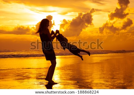 mother and  son playing on the beach in dawn time