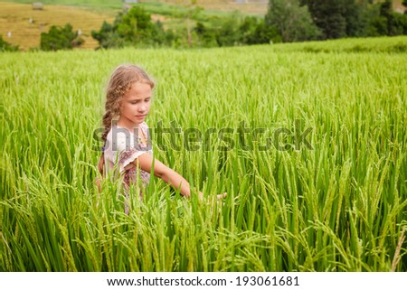 teen girl on the rice paddies in the day time