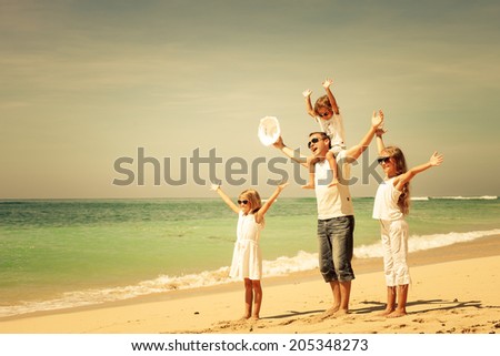 Happy family walking at the beach at the day time. Concept of friendly family.