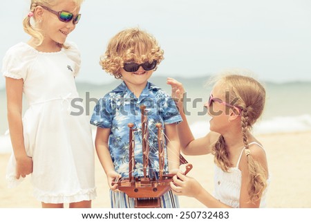two sisters and brother playing on the beach at the day time