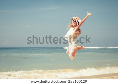 teen girl  jumping on the beach at blue sea shore in summer vacation at the day time