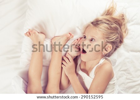 Lovely brother and sister lying in bed at home. Concept of Brother And Sister Together Forever