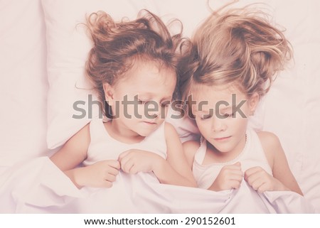 Lovely brother and sister lying in bed at home. Concept of Brother And Sister Together Forever