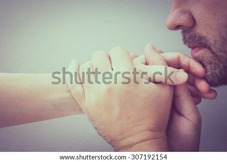 man kissing hand woman. Concept of couple in love at the day time