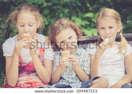 Three happy children  playing in the park at the day time. Concept Brother And Sister Together Forever