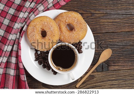 stock-photo-plate-with-coffee-cup-and-donuts-for-breakfast-on-rustic-wooden-table-top-view-286822913.jpg