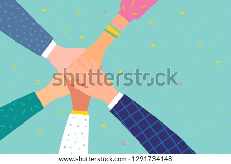 Concept of team work. Friends with stack of hands showing unity and teamwork, top view. People putting their hands together. International team building group of different race business partners. 
