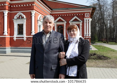 The mature couple posing by russian orthodox church