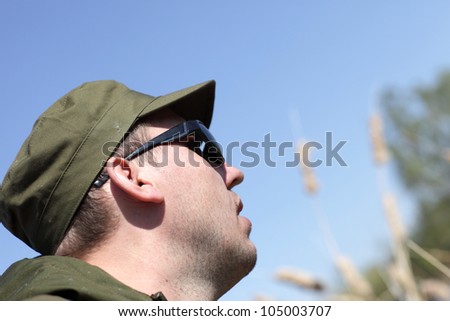 Man profile face on the sky background