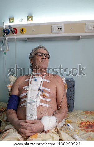 Patient after heart surgery in a hospital ward
