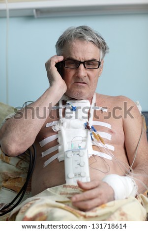 Patient with mobile phone in a hospital ward