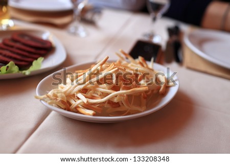 Chechil brined string cheese on a white plate