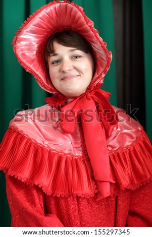 Woman is posing in a red historical clothing