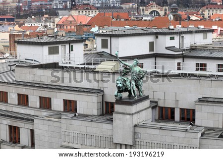 The metal statue of the lion and the genius on a building in Prague