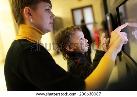 Family using touch screen in a museum
