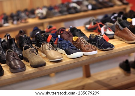 Shoes on the wooden shelf in the store