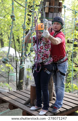 Couple climbing rope at the adventure park