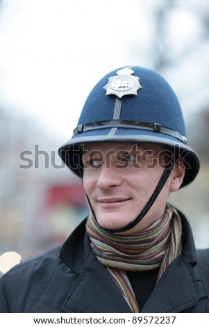The happy man posing in british police hat