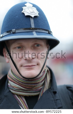 The man posing in british police hat
