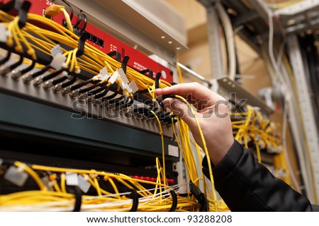The technician attaching fiber optic on the telecom site