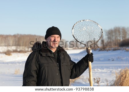 The fisherman posing with hand made ice fishing skimmer, Siberia