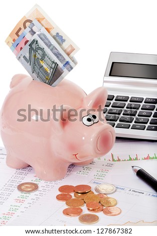 Piggy bank, stock prices and charts with stacks of euro coins and bills in front of white background