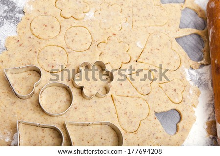 Cookie cutter in different shapes lie on cookie dough with Copy Space on the upper area