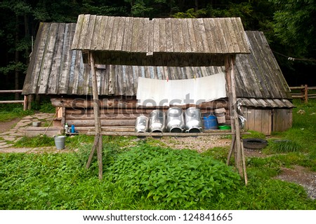Making oscypek cheese equipment. Milk duct and gauze in front of wooden mountain hut. Oscypek is a Polish traditional smoked cheese made of sheep\'s milk which is produces only in Tatra Mountains area.