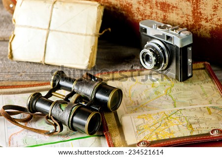 vintage  travel memories concept. Old camera, binoculars, letters and map-holder with map