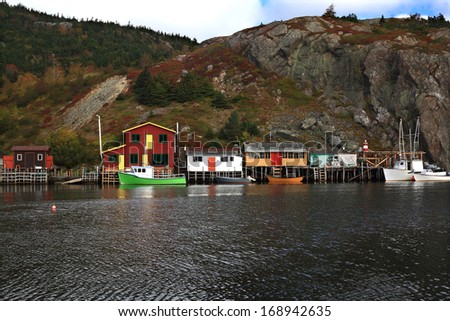 Fisherman Cabins and Docks (piers), Fishing Boats in Fall (October) on Quidi Vidi lake harbor, Newfoundland, Canada.