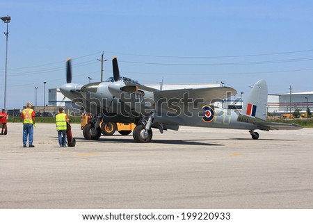 HAMILTON, ONTARIO/CANADA - JUNE 15, 2014: Legendary De Havilland Mosquito on Organized from Canadian Warplane Heritage Museum SkyFest for Fathers Day prepares for demo flight, right engine starts