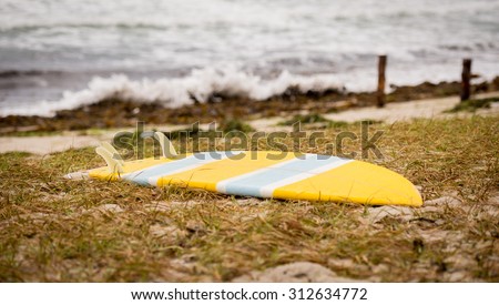 Surfboard at the sea sand