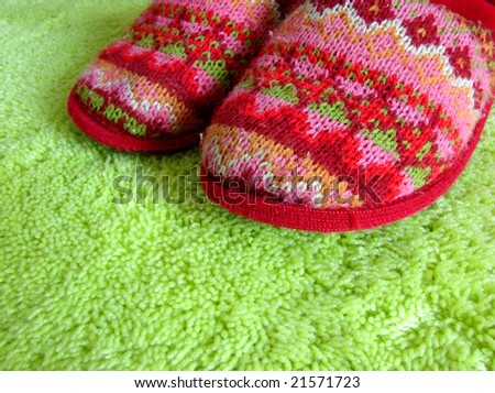 knitted decorative slippers and green carpet