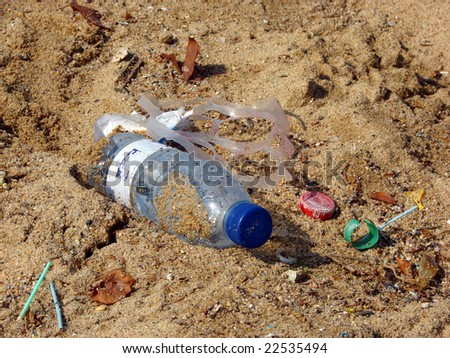 plastic bottle and dust on beach sand