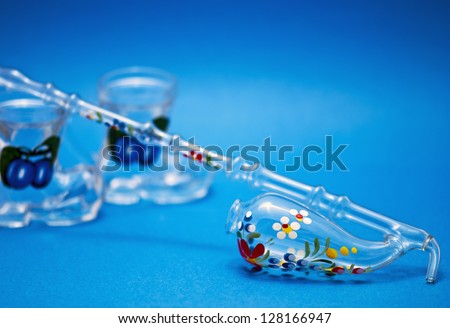 Decorative pipette with dram glass on blue background