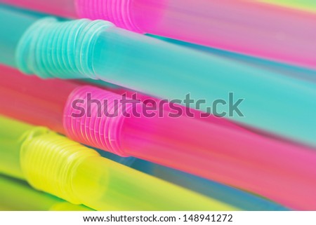 Stack of plastic colored drinking straws.