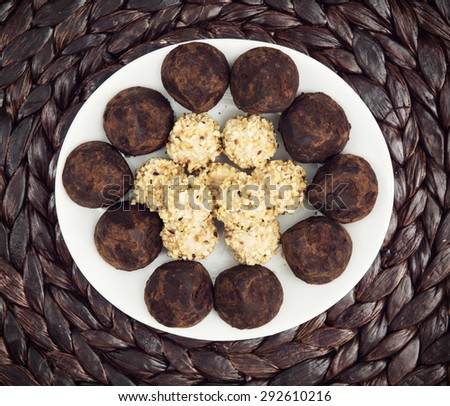 Chocolate truffles on the white plate. Food and drink. View from above.