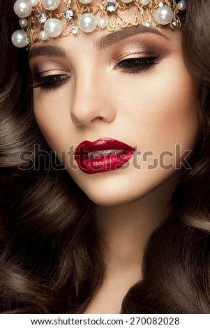 Beautiful young model with red lips and curly hair
