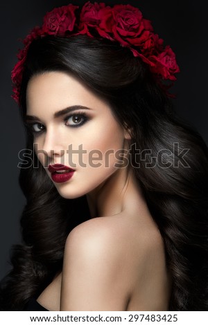 Beauty Fashion Model Girl Portrait with Roses Hairstyle. Red Lips.